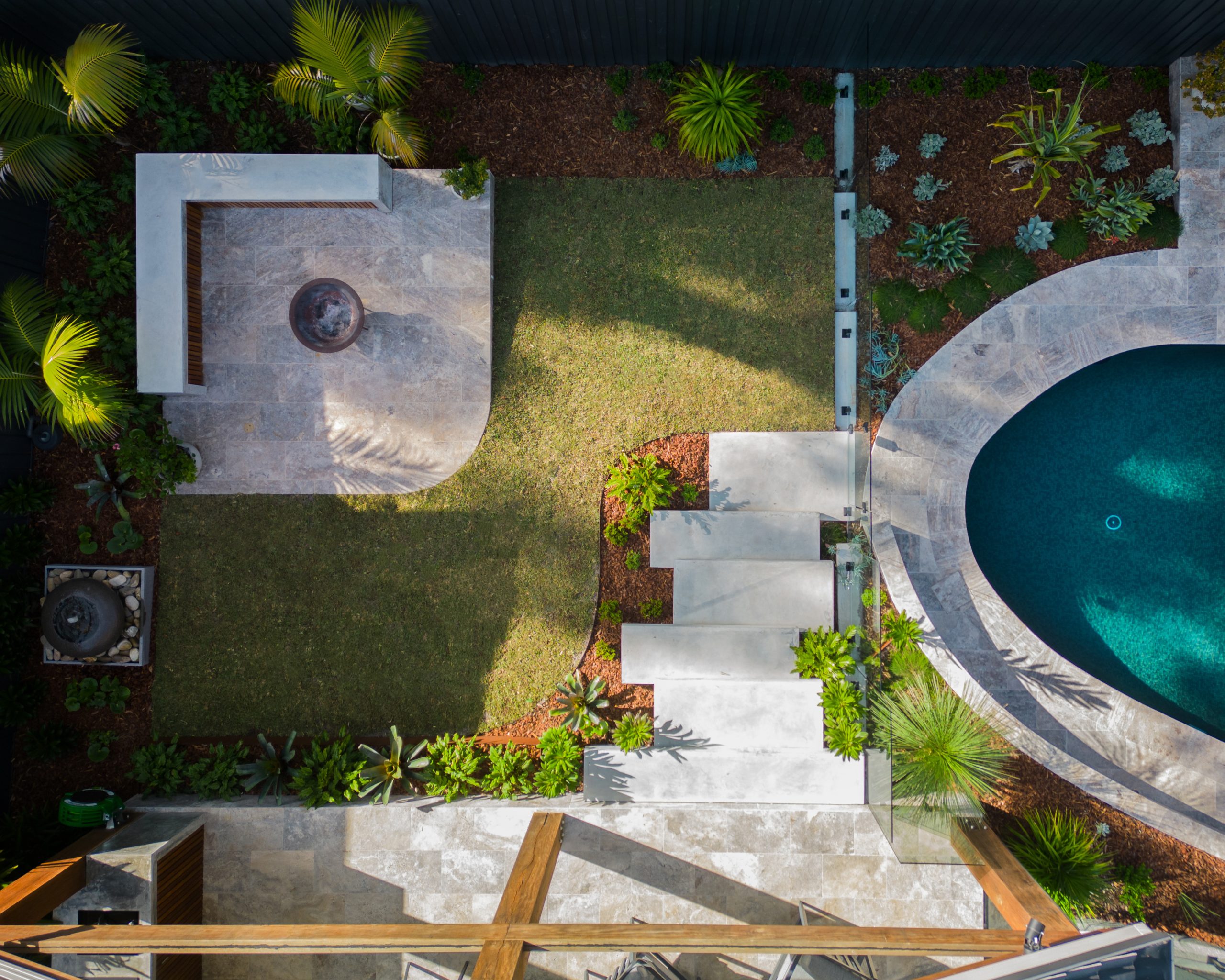 A backyard outdoor space with fire pit area and pool